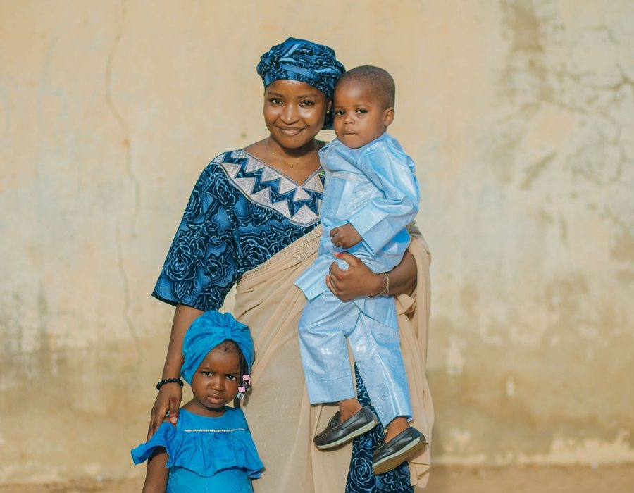 Nigerian parent with her children using the Samdos Parent App