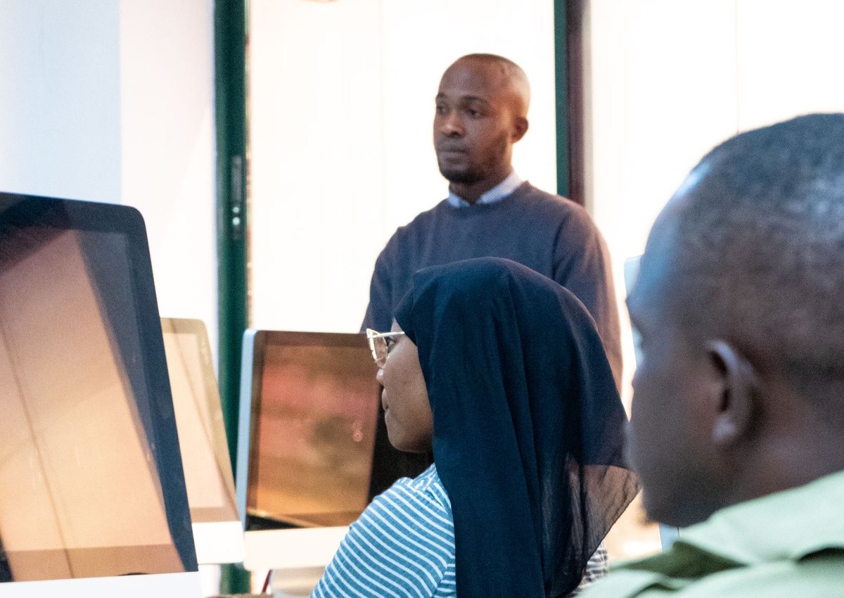 Students and a teacher working on computers in a Nigerian ICT lab